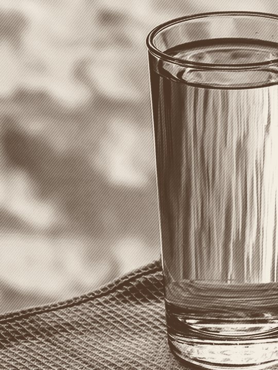 A glass of clear drinking water, advertising a free in-home water test by Jones Air & Water